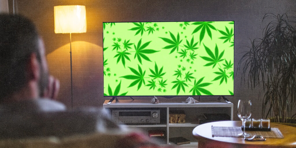 man watching tv with cannabis leaves
