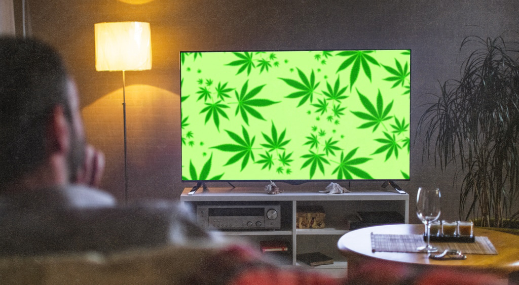 man watching tv with cannabis leaves