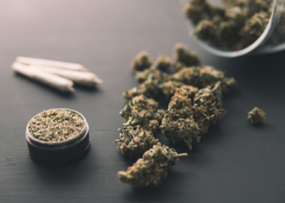 cannabis flower and prerolls on table